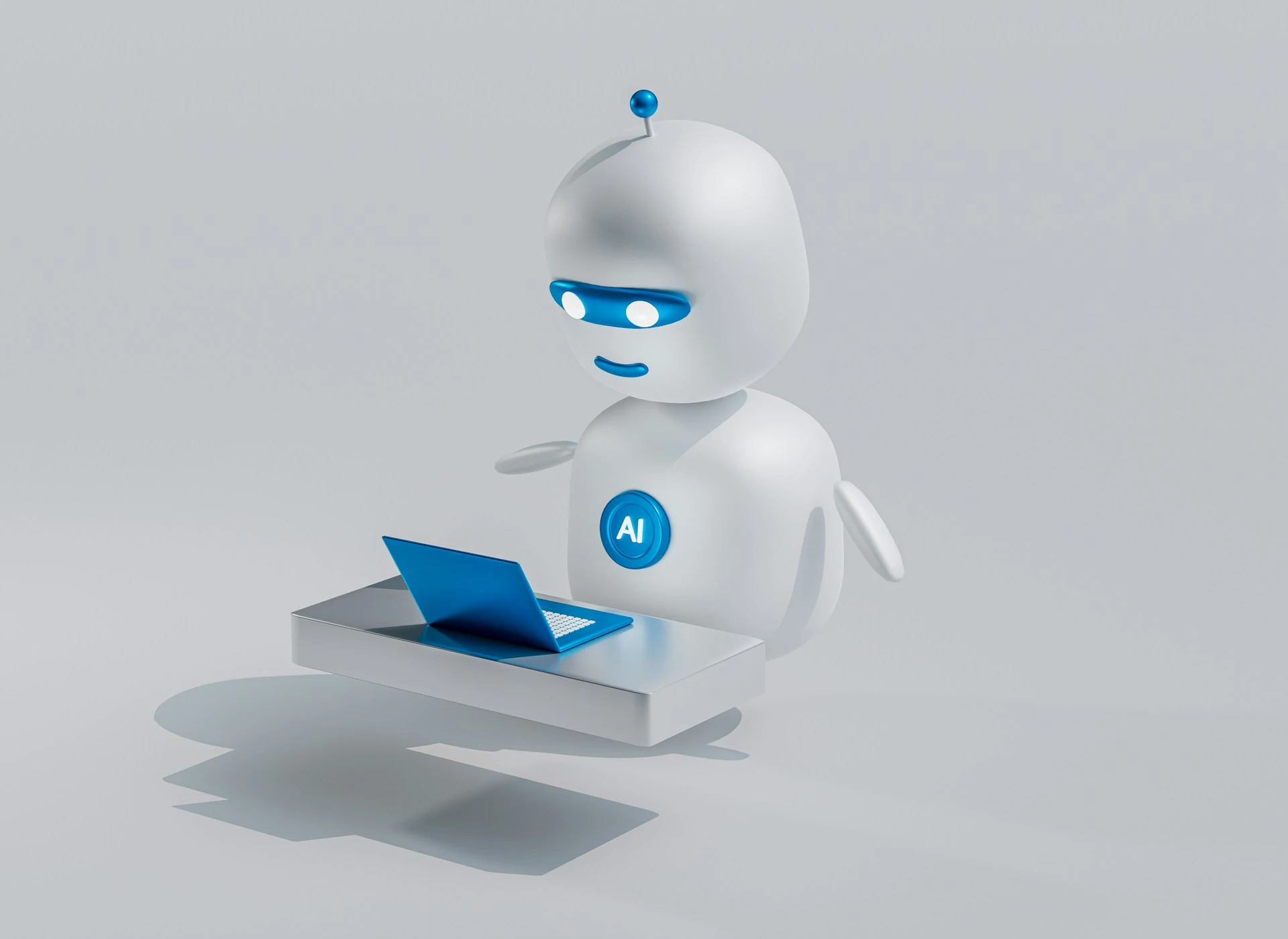 A small, friendly white and blue AI robot at a desk with a laptop.