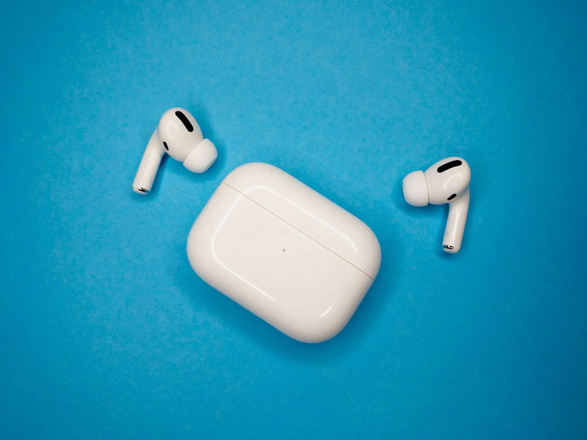 AirPods Pro on blue background.