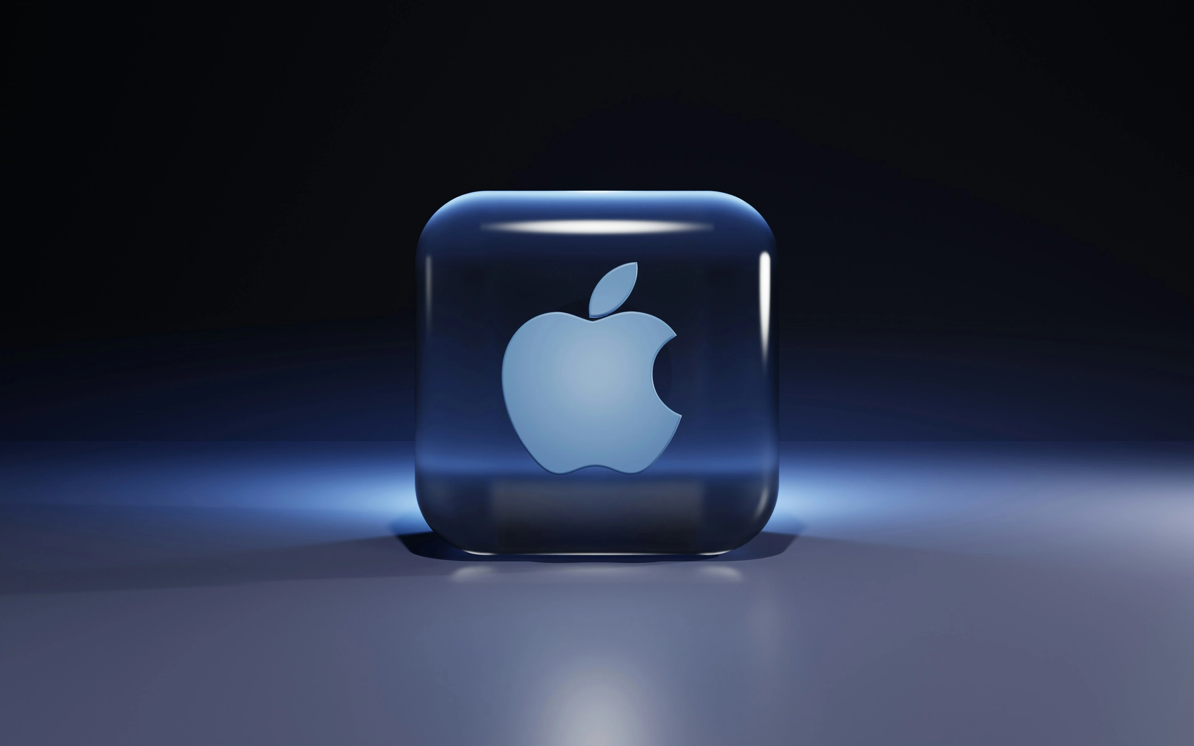 Blue glowing Apple logo inside a translucent glass cube.