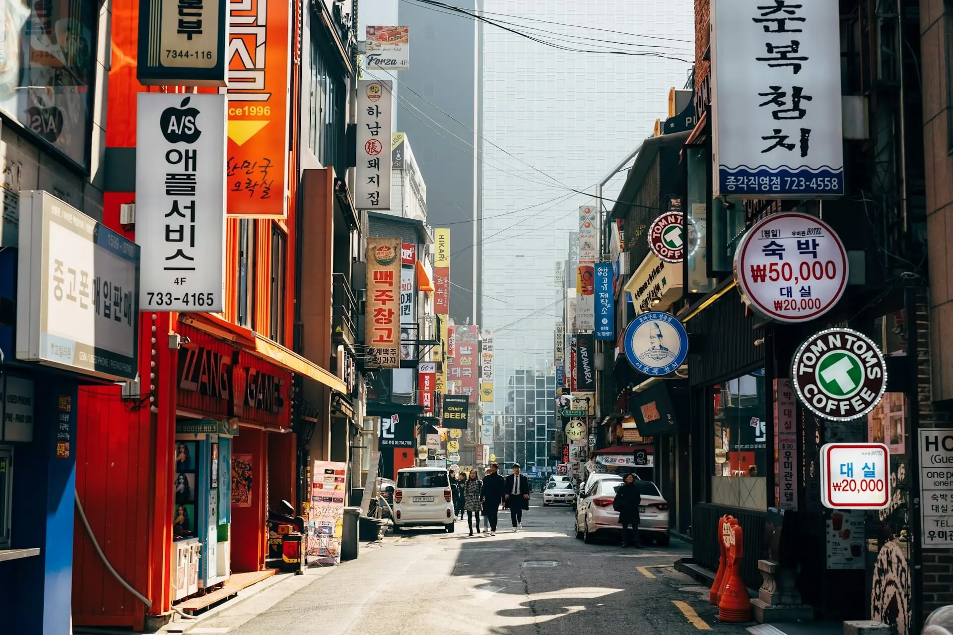A street in Seoul with vertical signs featuring Korean text.