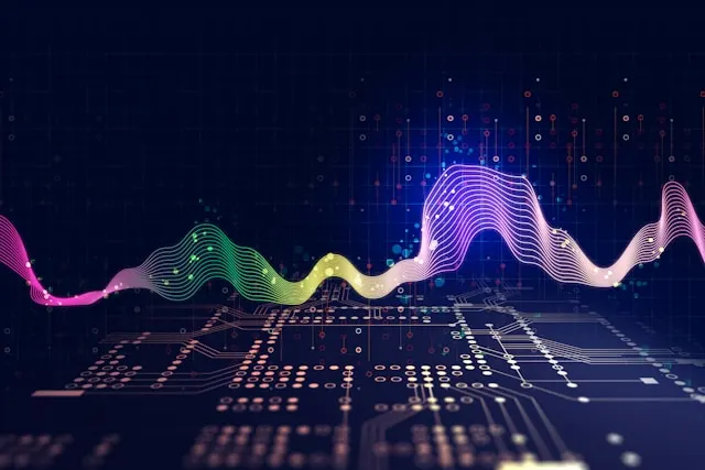 Colorful audio waveform over a dark circuit board.
