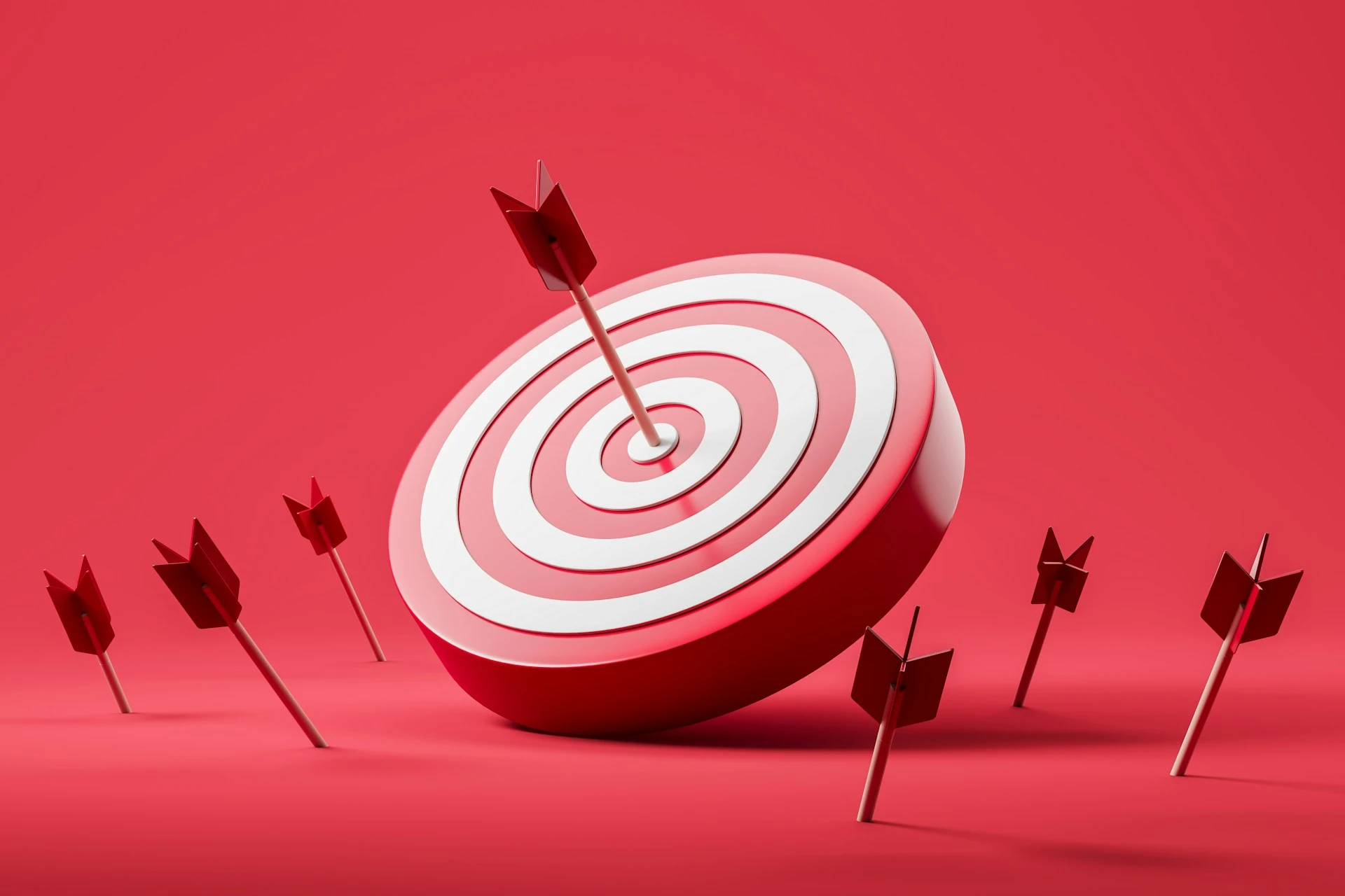 Red and white target with one arrow hitting the bullseye.