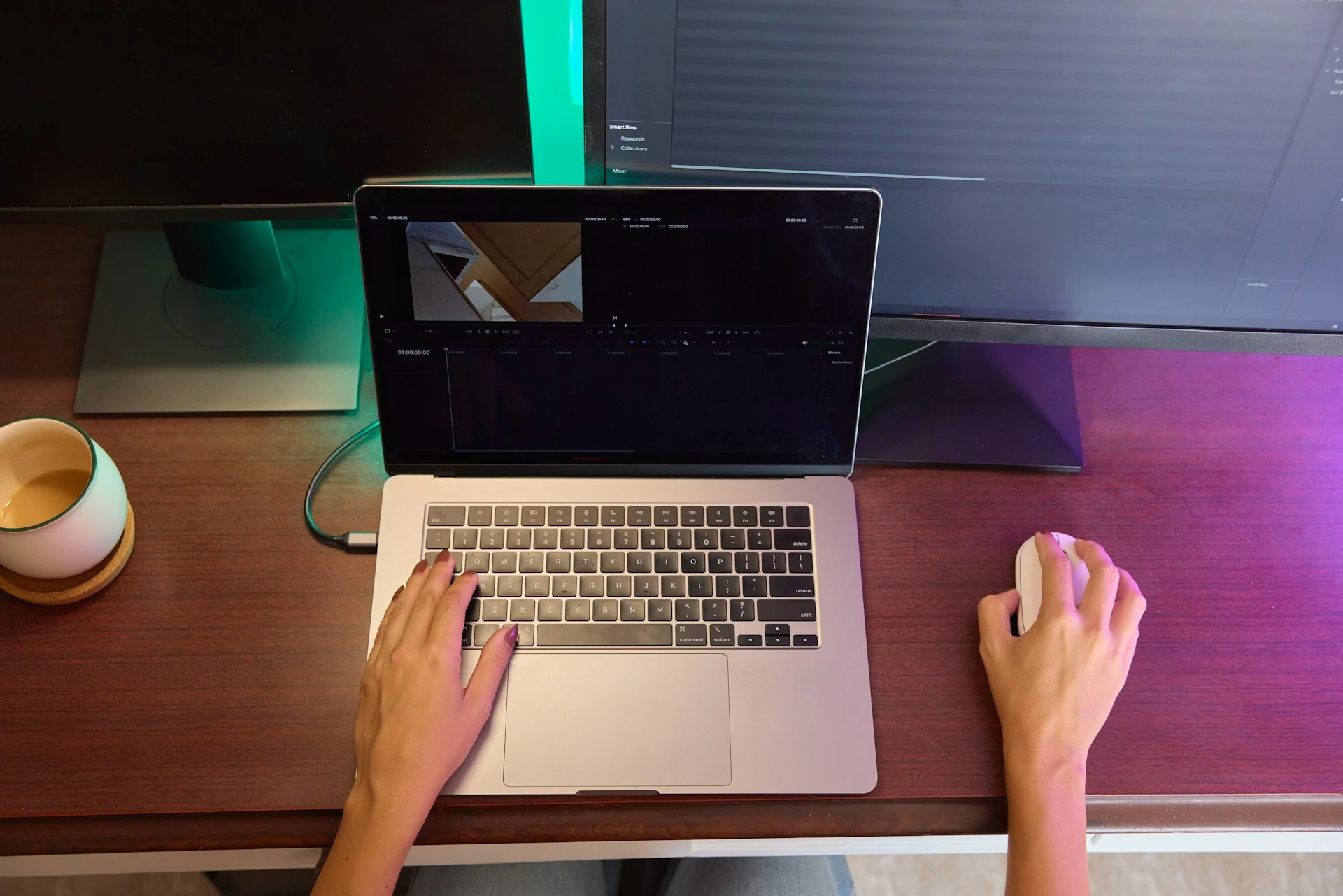  A top-down view of a person editing video using a laptop.