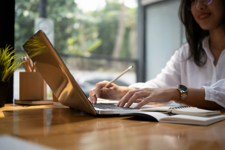 A woman transcribing using a computer.