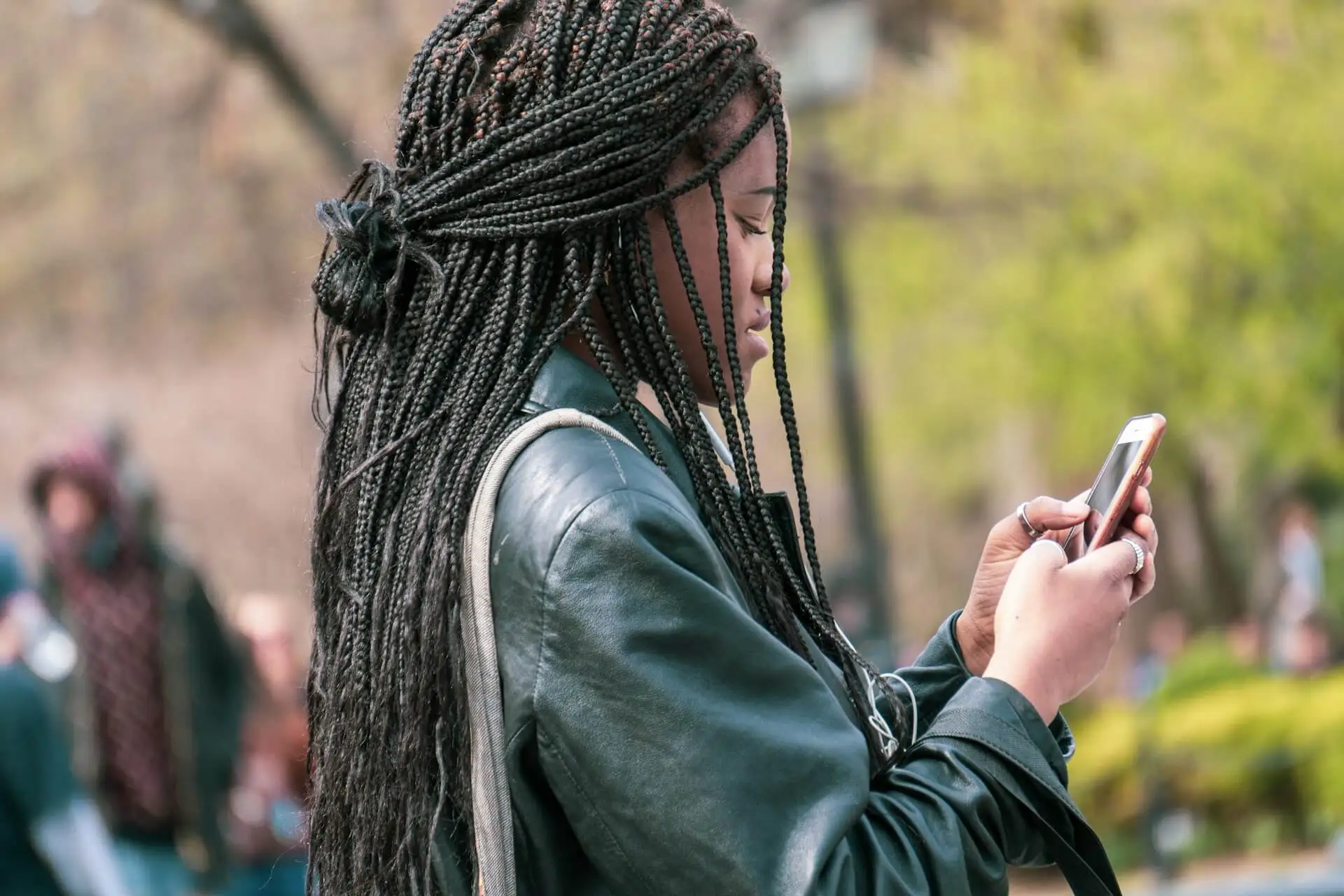 Young woman uses a smartphone outdoors.