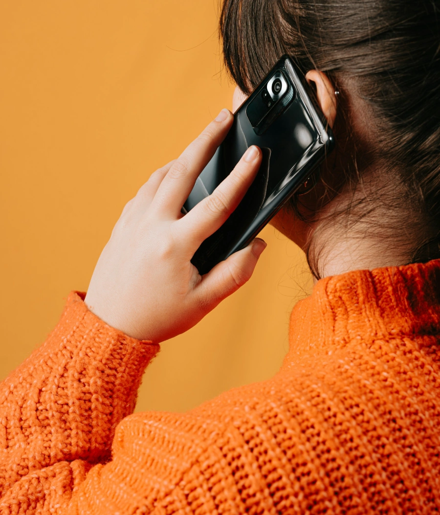A woman listening to a voice memo on her Android phone