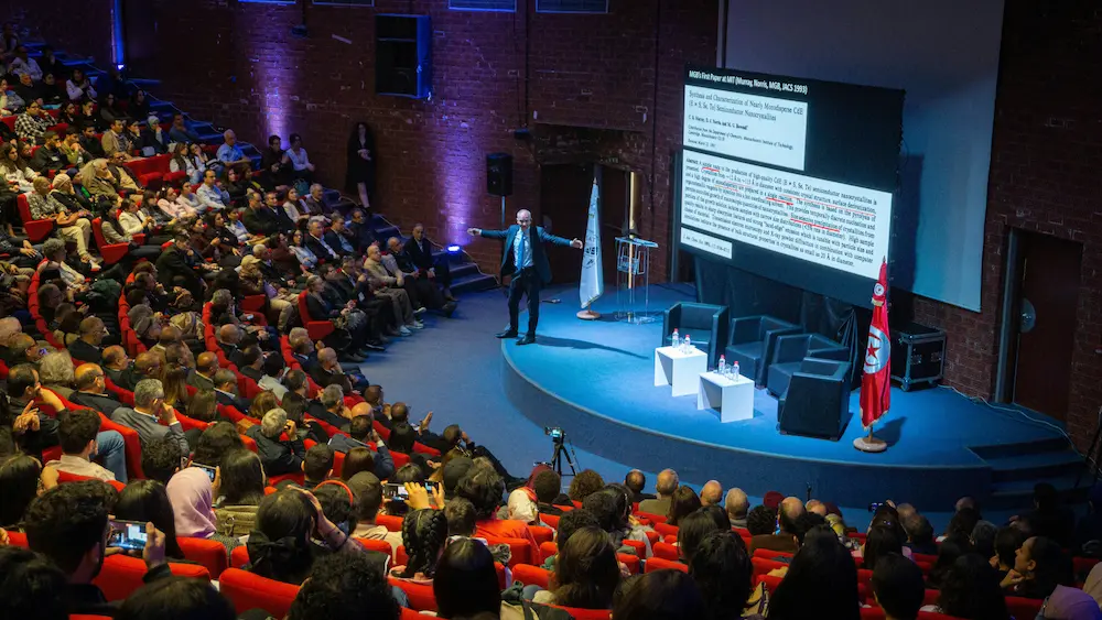 Speaker presenting to a full conference hall