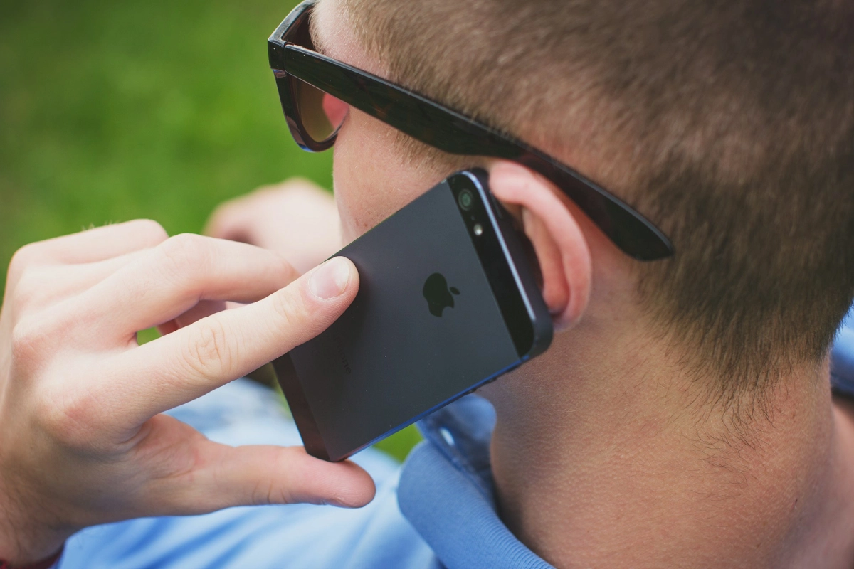 A woman listening to a voice memo on her iPhone