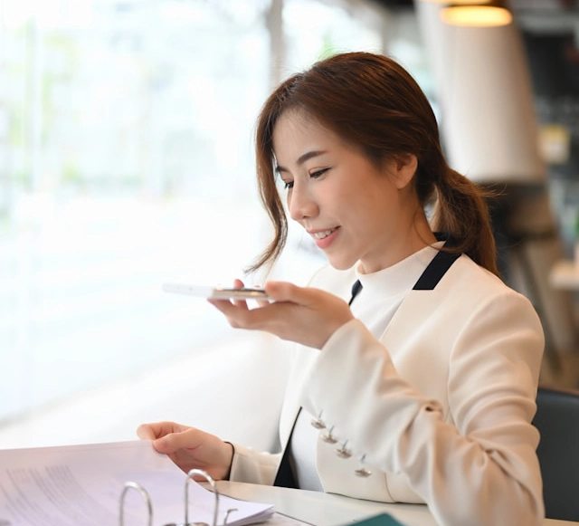 A person listening to a voice memo on their phone