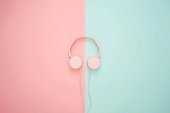 Pink headphones on pastel backgound.