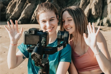 Two content creators in front of a camera.