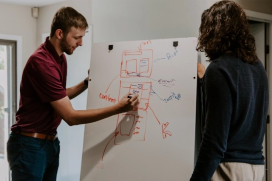 Two co-workers planning a new strategy to get more views on Instagram reels.