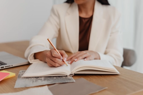 A recruiter taking notes by hand.