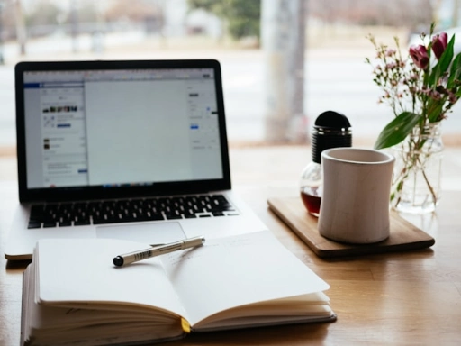 A laptop with a notepad and pen.