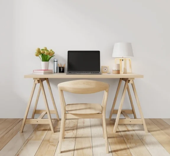 A clean desk and chair in a study room.