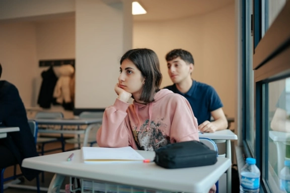 A close up of a student listening to the lecturer in class.