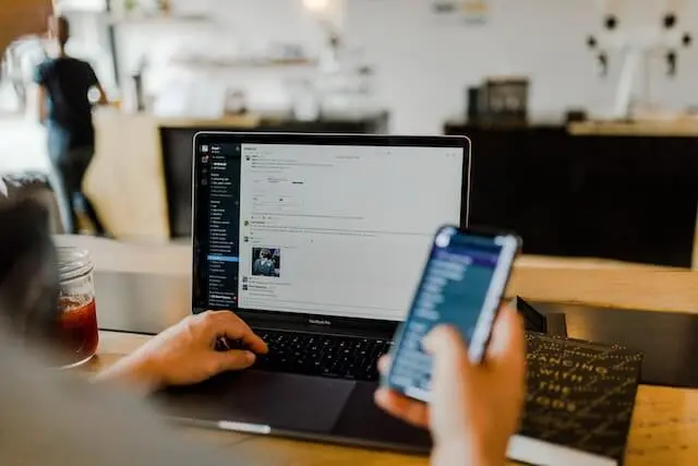 A person is using the Slack app to communicate on desktop and mobile.