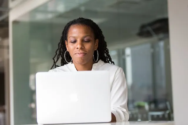 A woman typing on her laptop.