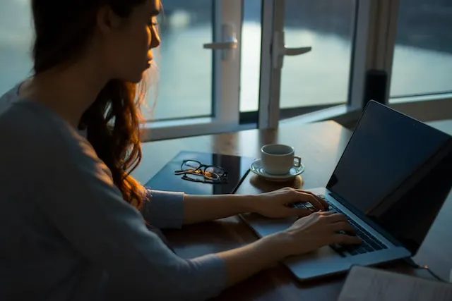 A woman working on her laptop.