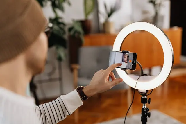 A man getting ready to shoot a video with a smartphone.