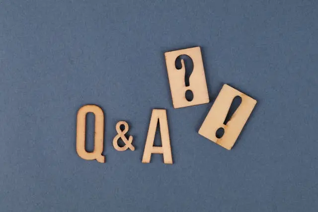 The letters Q & A, a question mark and an exclamation point displayed on grey background.