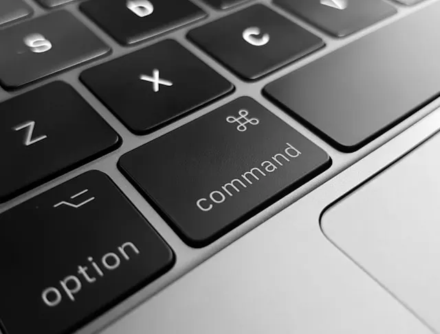 A Macbook keyboard with a close-up on the Command button.