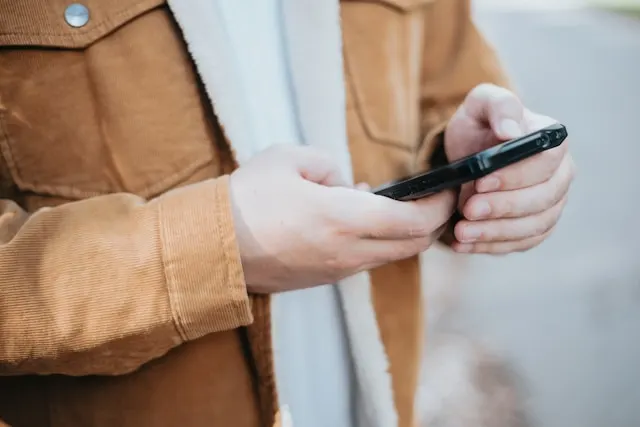 Close up shot of a person holding a smartphone.