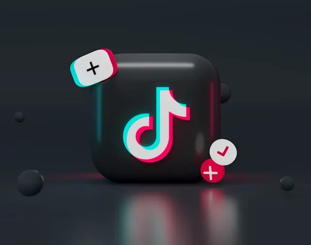 TikTok logo on black surface.