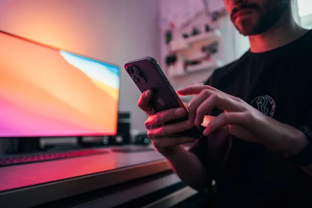 Close up of a man using his smartphone.