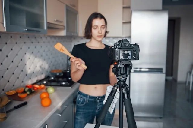 A video content creator in a kitchen ready to shoot a recipe video.