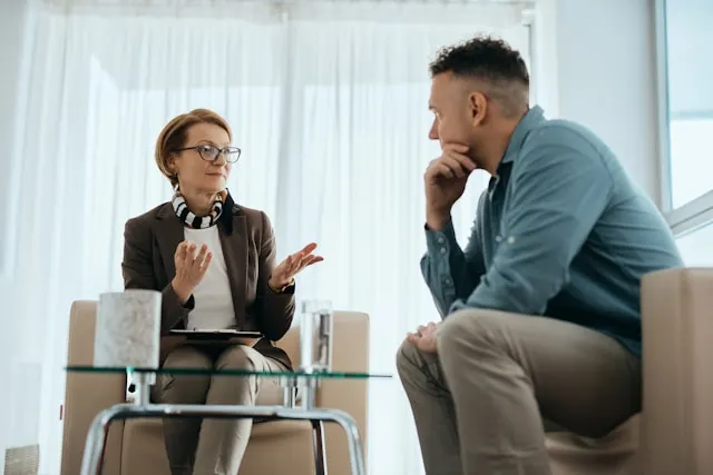 A woman and a man having a one-on-one meeting.