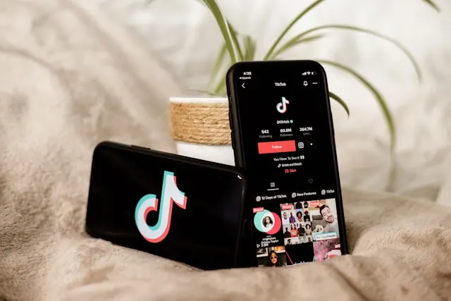 Two smartphones; one displaying the TikTok logo and another a TikTok feed.