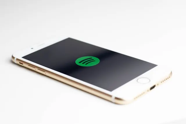 A smartphone screen displaying the Spotify logo.