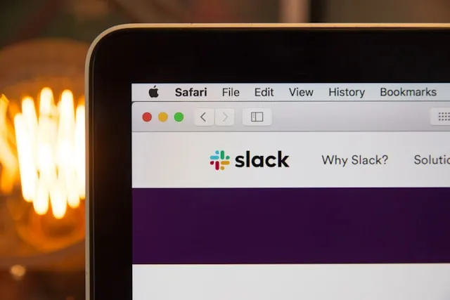 The web page of Slack on a laptop screen.