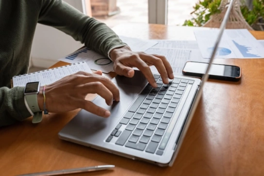 A person typing on a laptop.