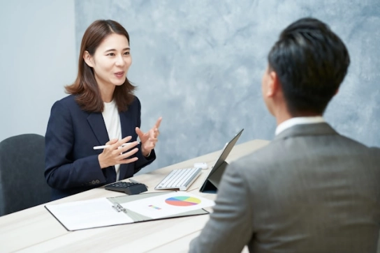 A woman and a man having an interview in a professional setting.