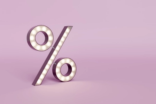 Percentage symbol on pink background.